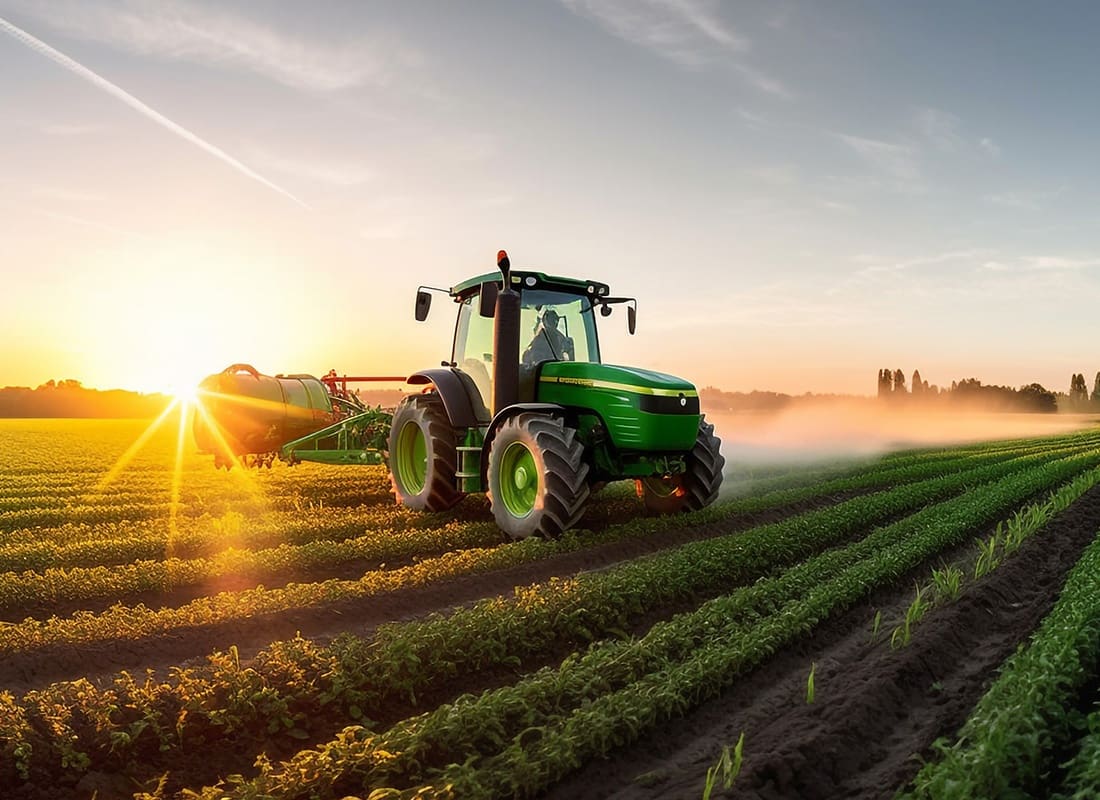 Business Insurance - Green Tractor on a Crop Field